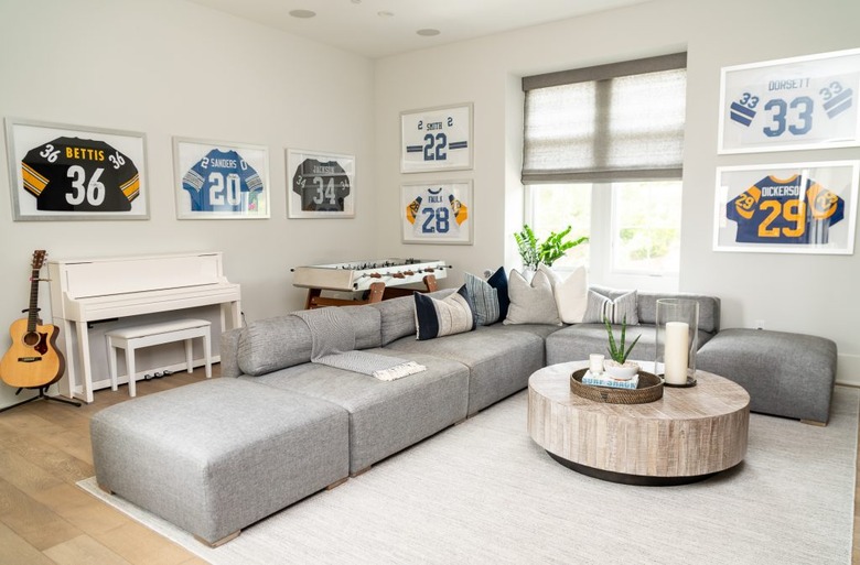 family room furniture with modular gray sectional and framed sports memoribilia