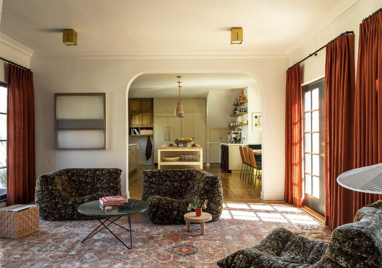 family room furniture with green patterned chairs and burnt orange velvet curtains