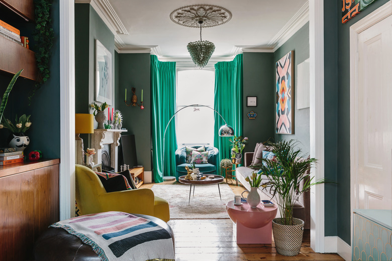 green family room window treatments in green room with yellow chair and colorful accents