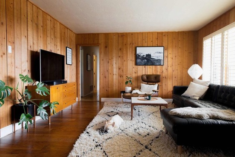 wood paneled family room with traditional family room window treatments