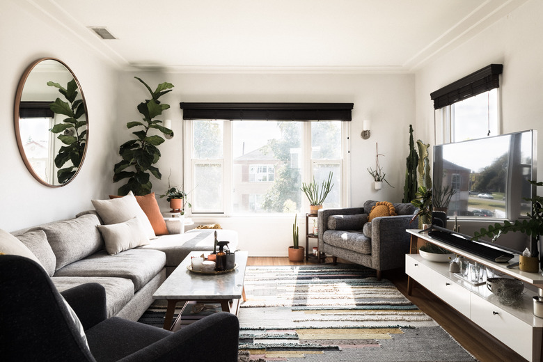 black family room window treatments in bright family room with white walls and midcentury modern coffee table