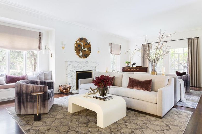 velvet family room window treatments in white family room with cream coffee table and roman shades