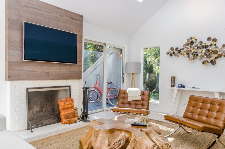 Family room with fireplace and TV layout paired with honey leather chairs.