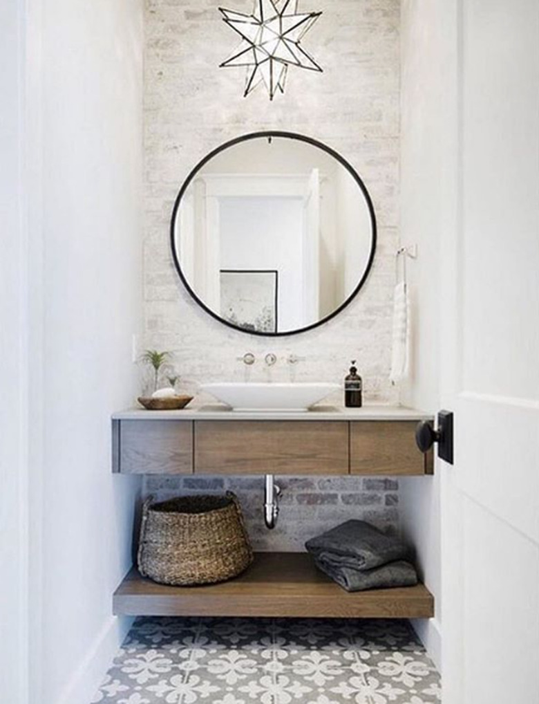 farmhouse bathroom lighting with a star shaped pendant light over a floating wood vanity and patterned floor tile