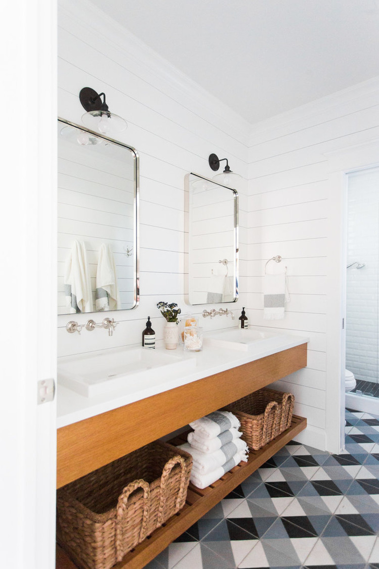 patterned floor tile and shiplap walls with farmhouse bathroom lighting