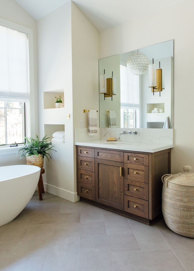 Farmhouse bathroom storage designed by Michelle Lisac Interior Design with baskets and under the sink storage