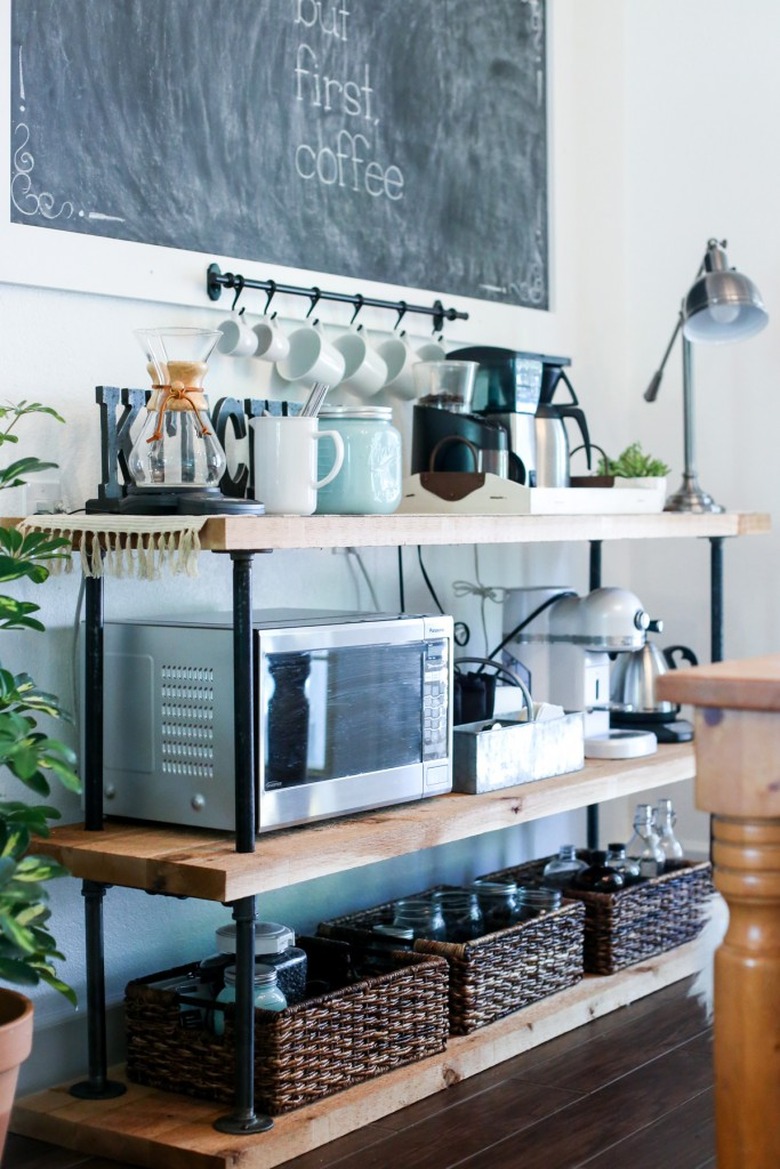 Farmhouse coffee bar with industrial pipes, wood shelves, and small kitchen appliances