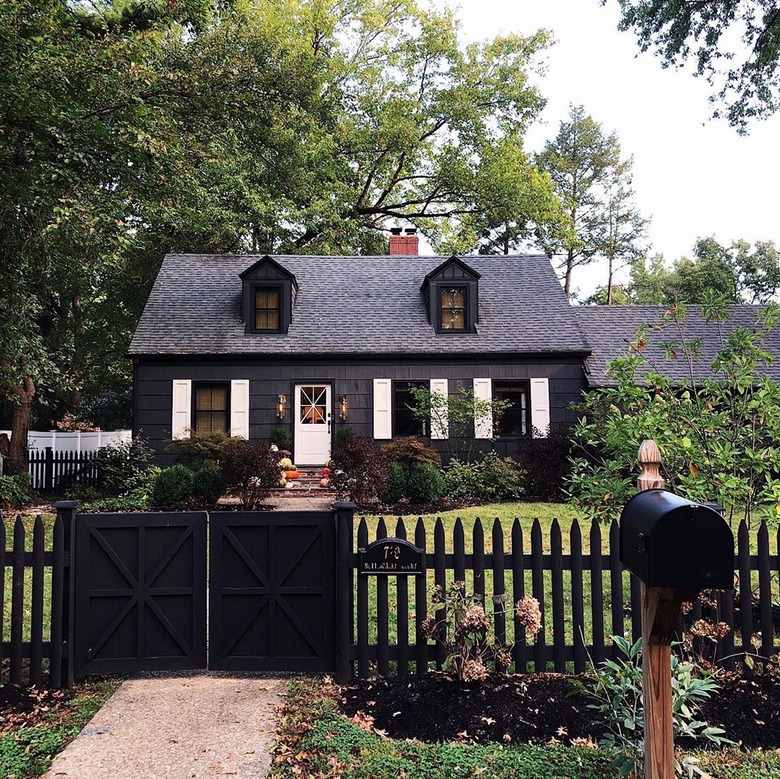 Black farmhouse exterior colors showcased on black cottage