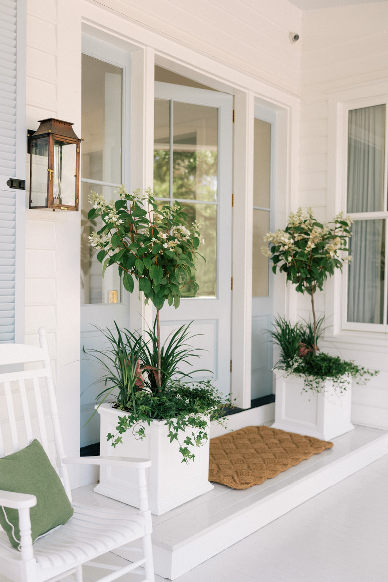 White and light blue farmhouse exterior colors on front porch