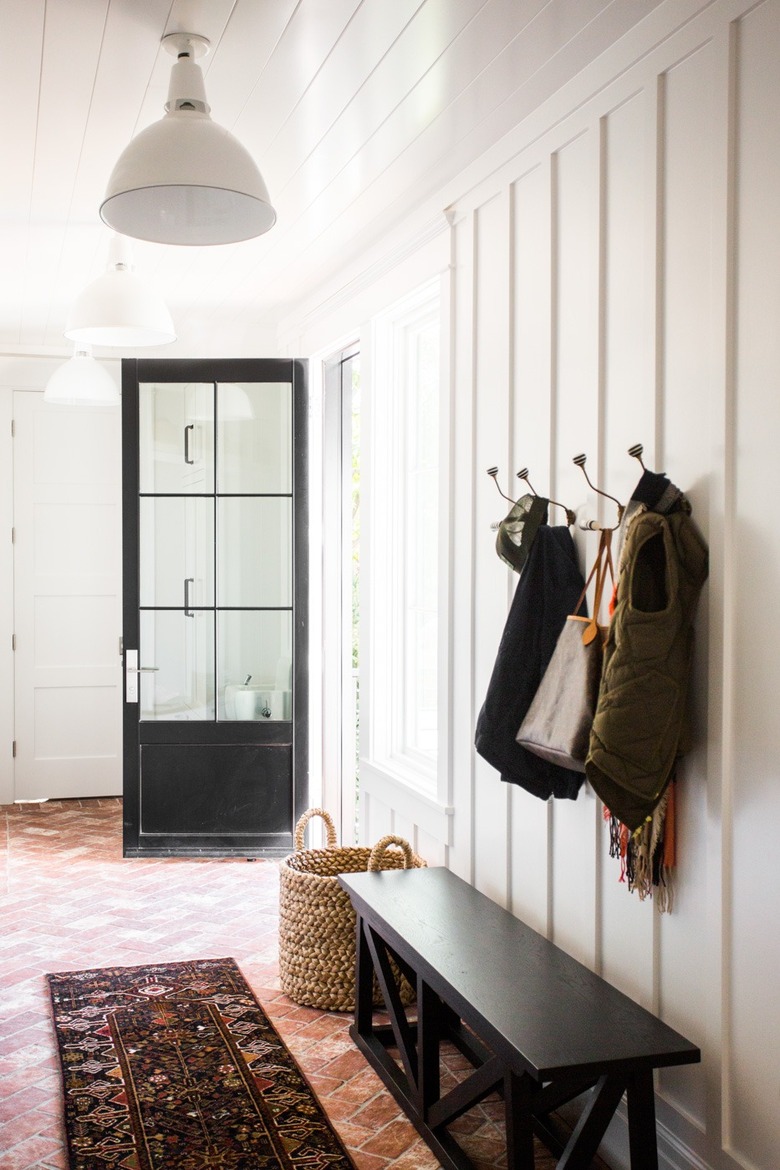 farmhouse flooring idea in mudroom with brick floors