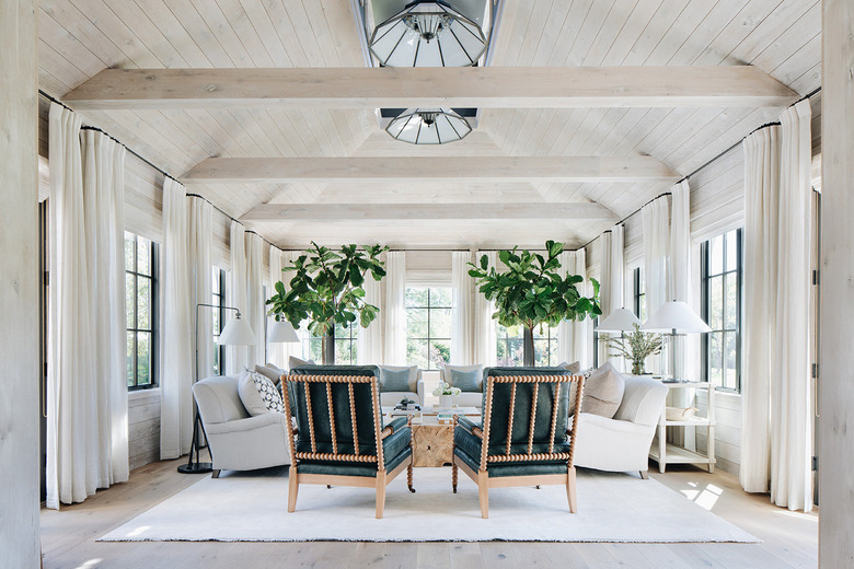 neutral living room with pitched ceiling and drapery