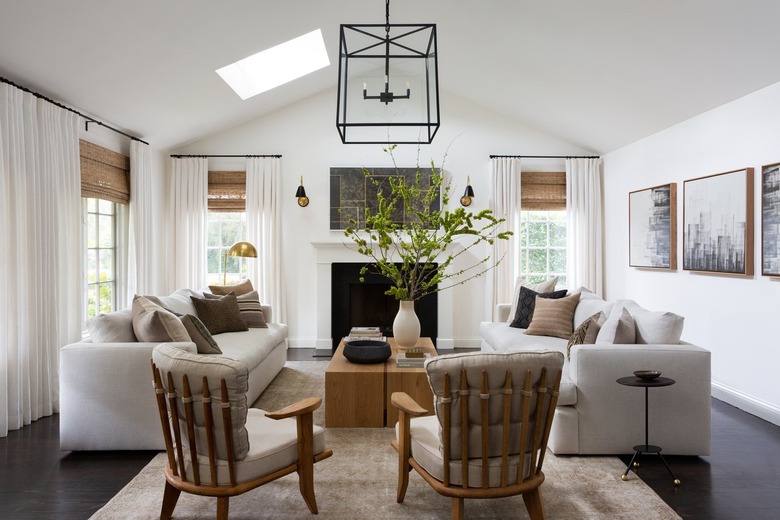 living room with cage pendant light an unusual chairs