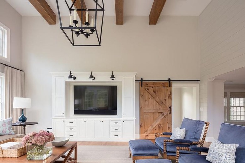 living room with reclaimed wood barn door and beams