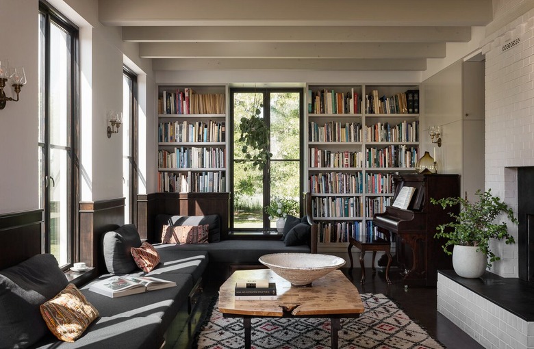 living room with floor to ceiling bookshelves