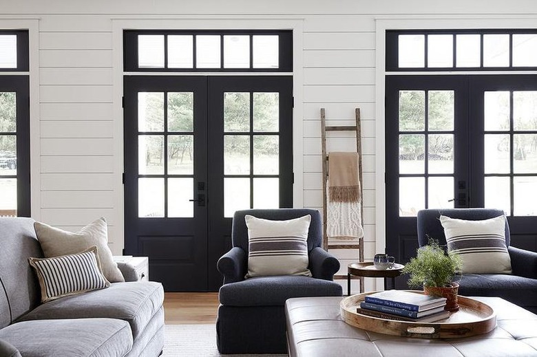 high-contrast living room with white walls and black doors