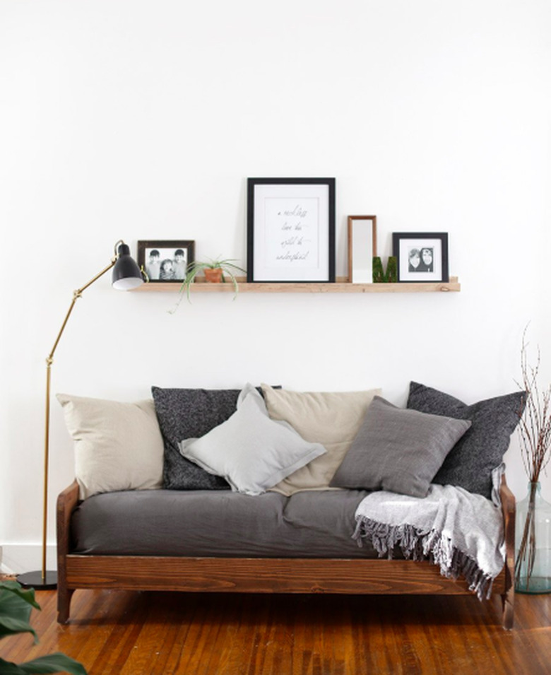 farmhouse living room lighting idea with black and brass floor lamp next to sofa