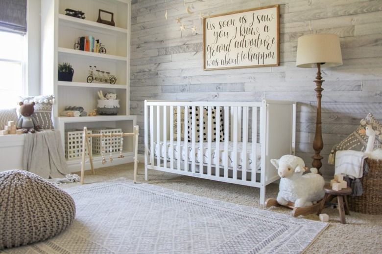 farmhouse nursery idea with wood paneled wall and open shelving