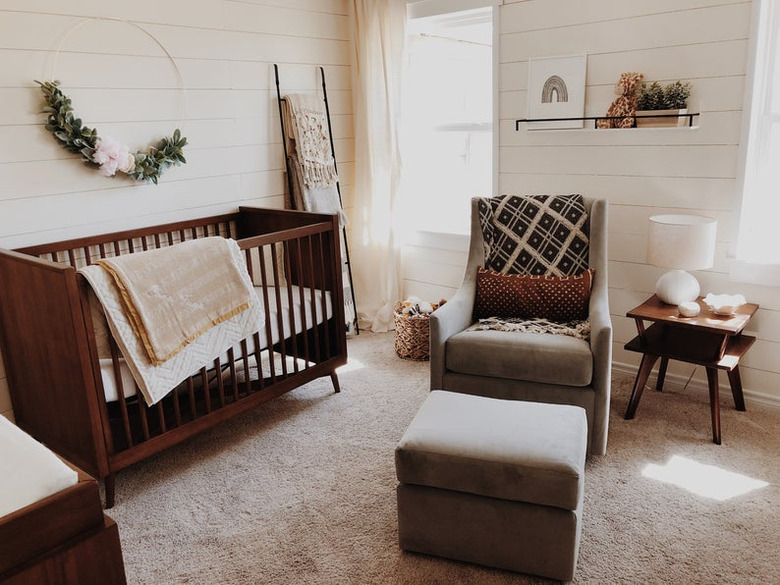 farmhouse nursery idea with floral wreath on shiplap walls