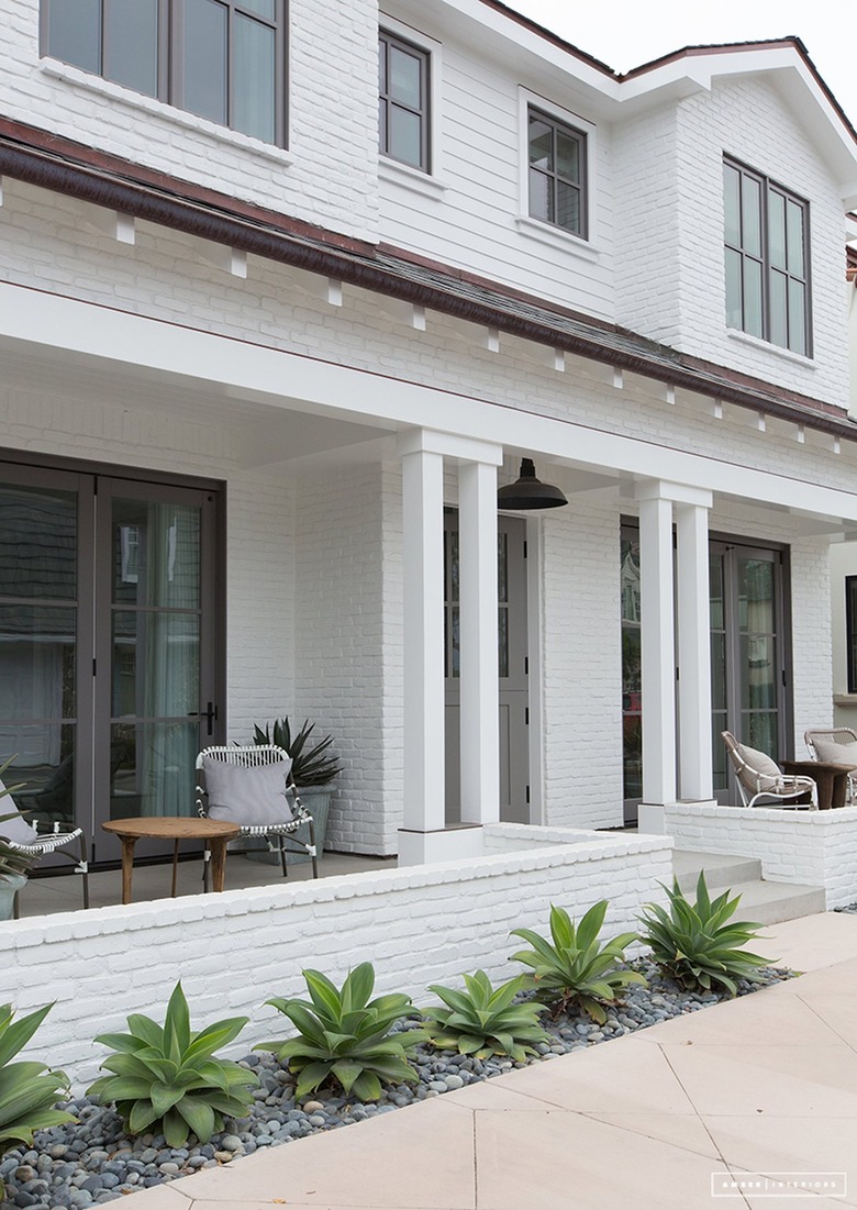 white porch surrounded by succulents