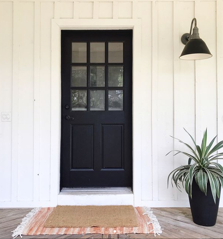 farmhouse porch idea with board and batten siding and black front door