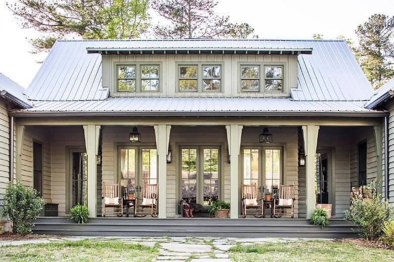 green/gray home with gray roof and porch