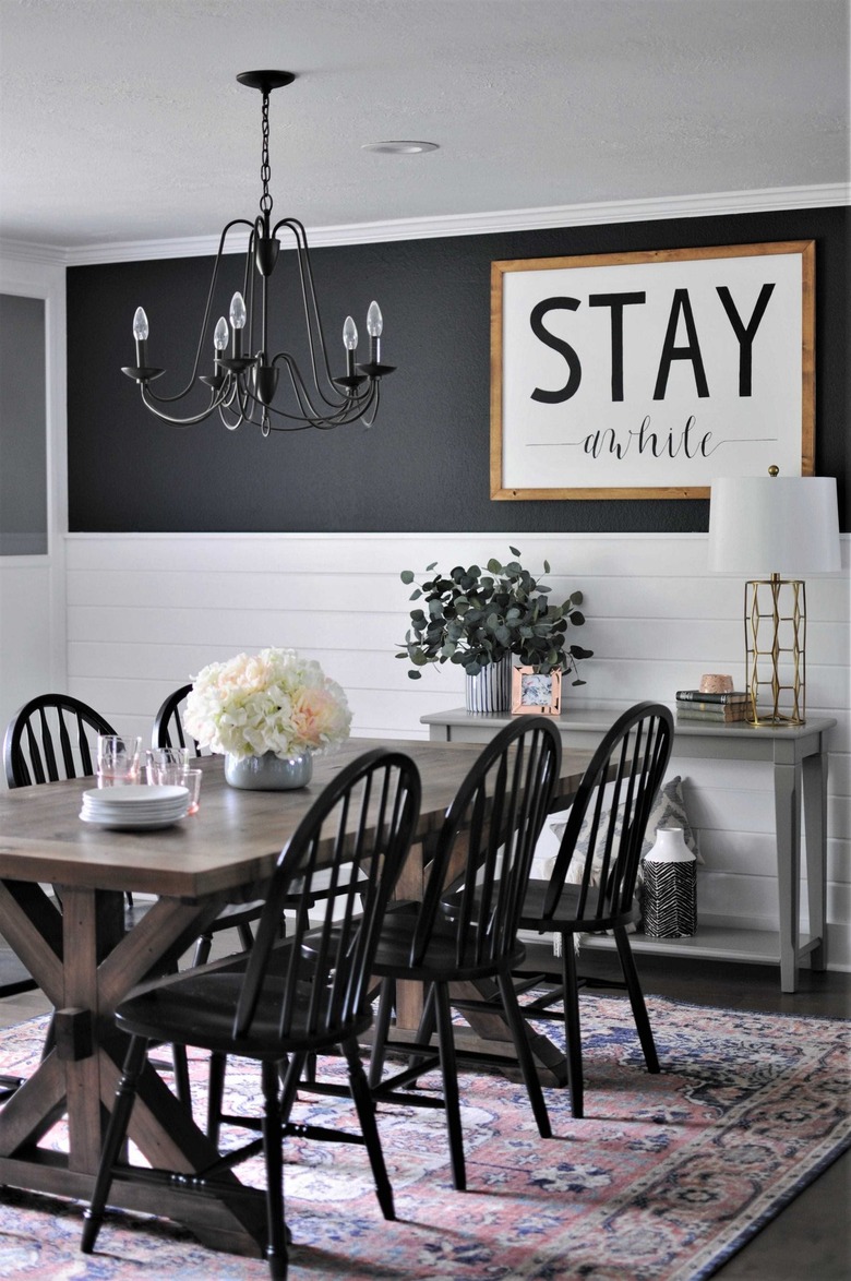 black and white farmhouse dining room with sign