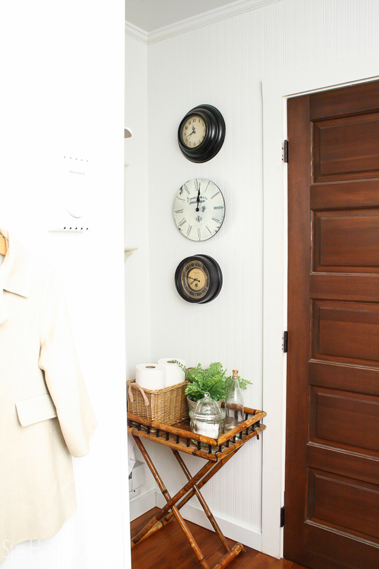 three antique clocks on a wall