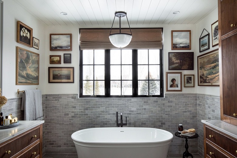 bathroom with vintage artwork gallery wall