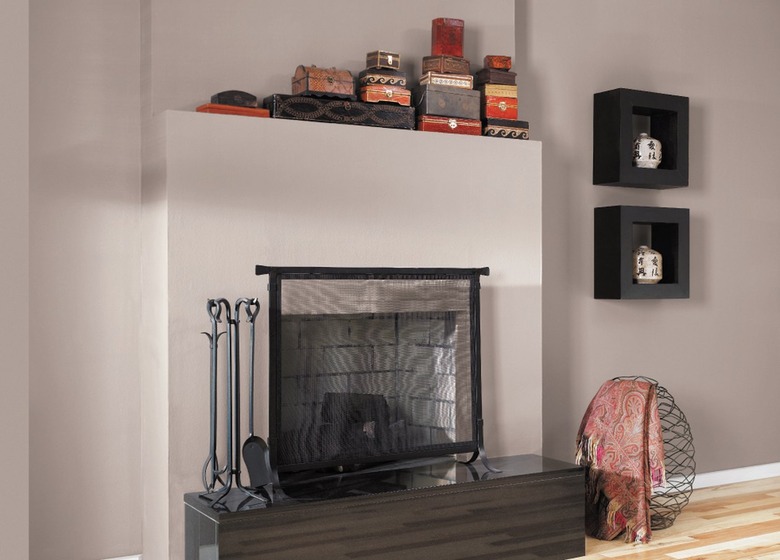 fireplace area with decor and black shelves nearby