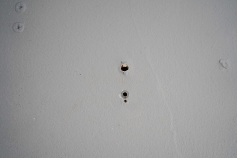 Small drill holes in a wall