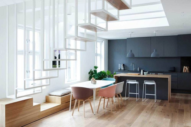 white floating stairs with dining room below