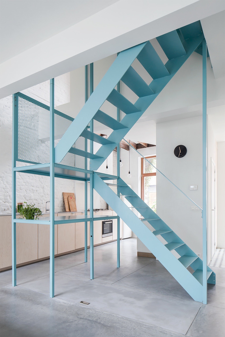 blue floating stairs in minimalist home