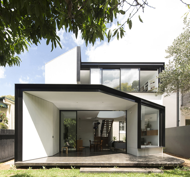 white contemporary home exterior with floor to ceiling windows