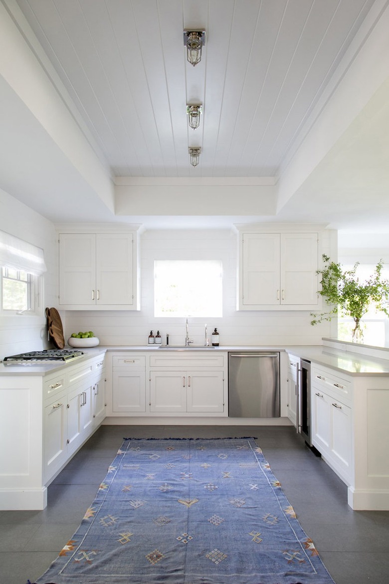 white kitchen with industrial caged flush mount light fixture