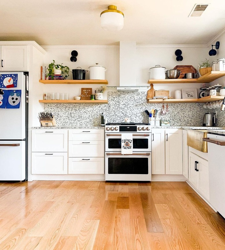 white contemporary kitchen with brass and frosted glass flush mount light fixture in the center