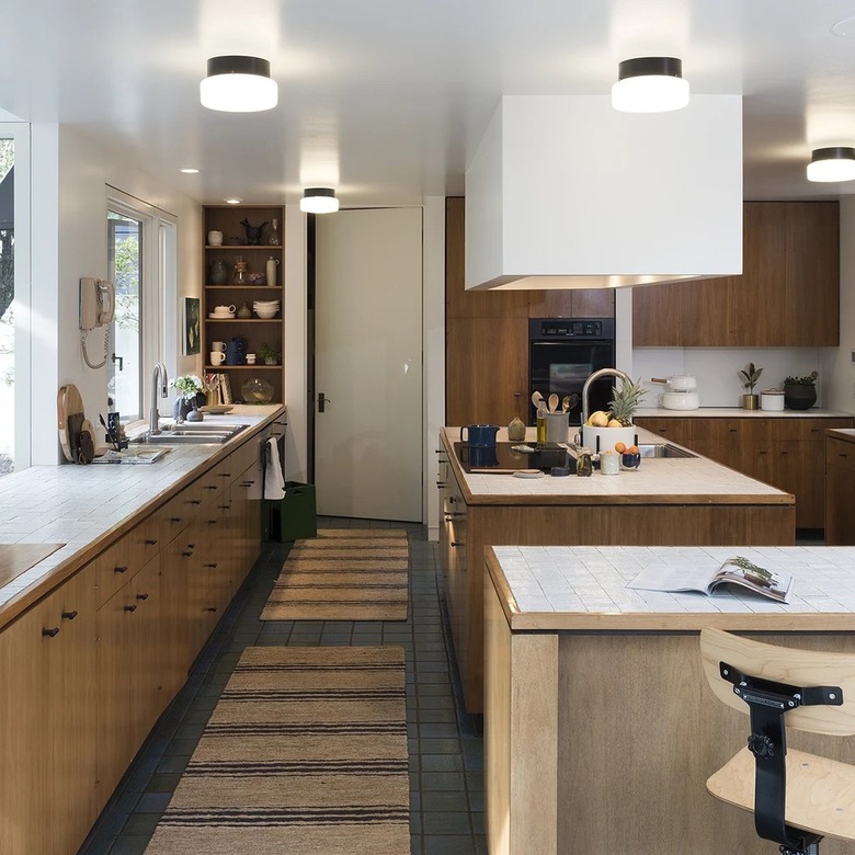 brown and white kitchen with frosted glass flush mount light fixtures