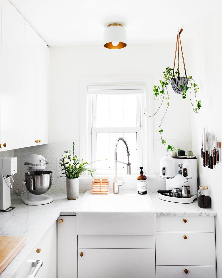 white kitchen with white and brass flush mount light fixture