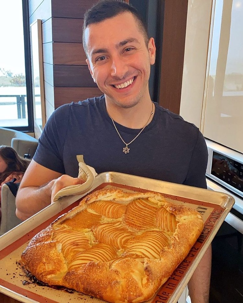 jake cohen holding a pear & vanilla frangipane galette