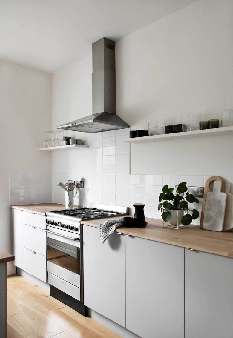 neutral kitchen with gray cabinets and butcher block countertops