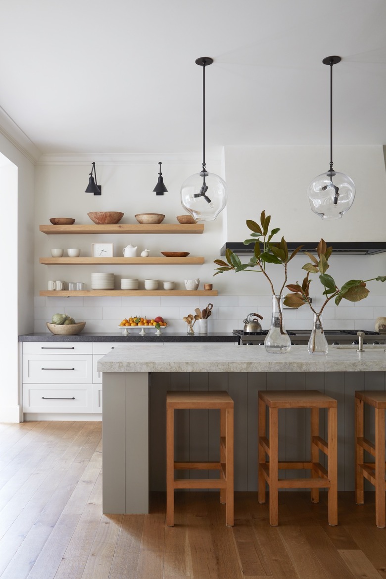 white kitchen with gray island and open shelving