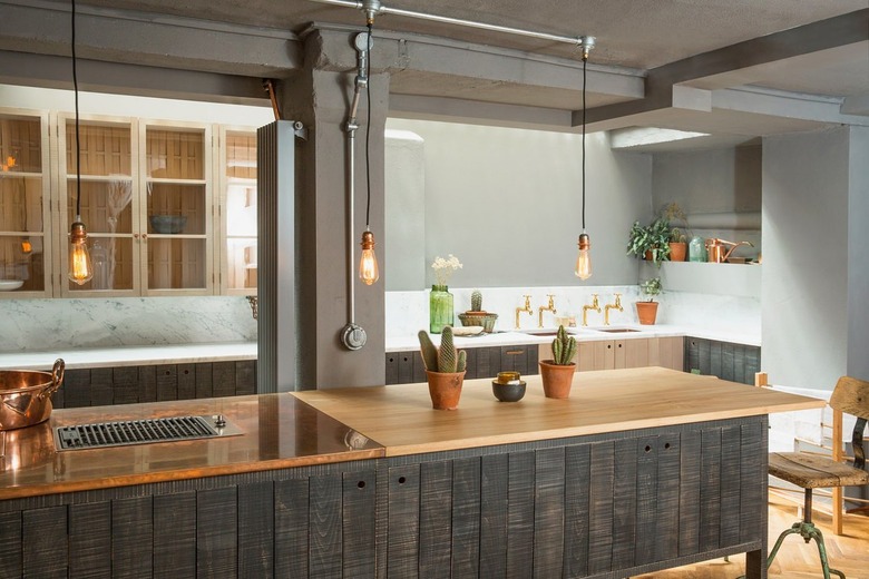 gray kitchen with distressed gray cabinets and wooden floors