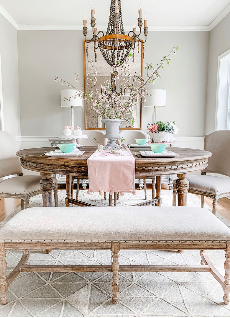 French country dining room idea with round table and chandelier