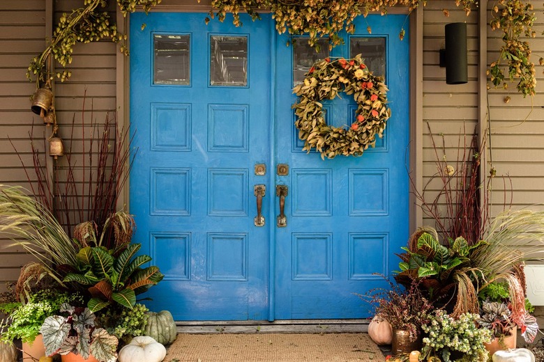 blue front door with fall wreath