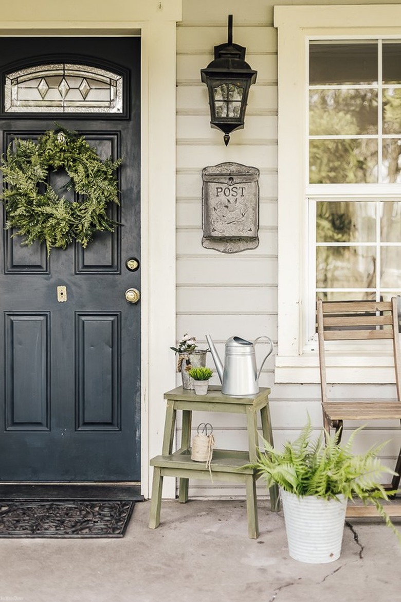 black front door color with green wreath