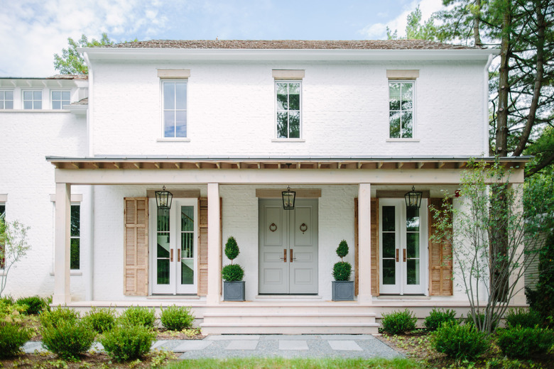 sage green front door color on white house