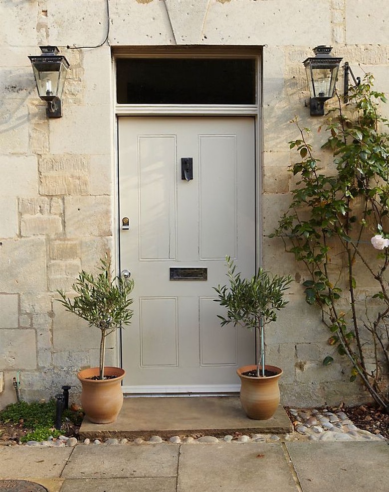 gray front door color with stone exterior