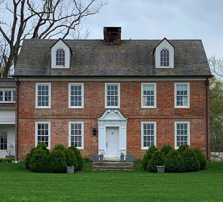 colonial brick home with white door