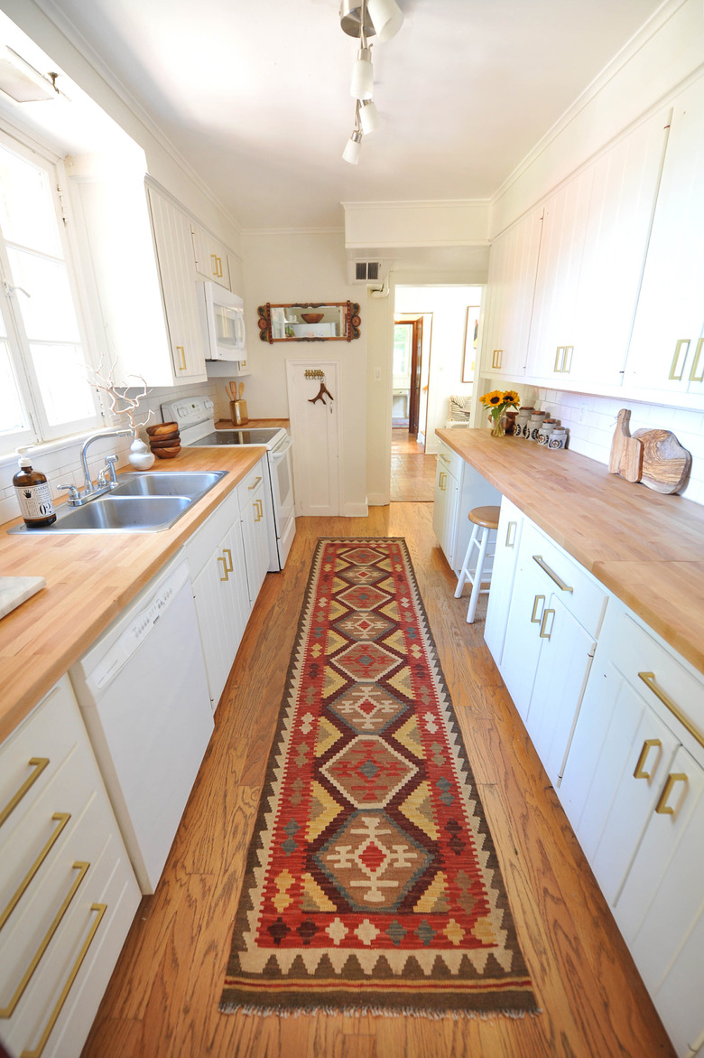 galley kitchen with wood flooring and countertops