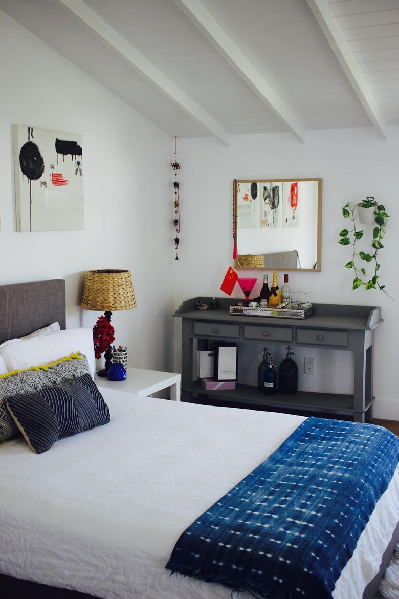 converted garage bedroom idea with bed and desk against the wall