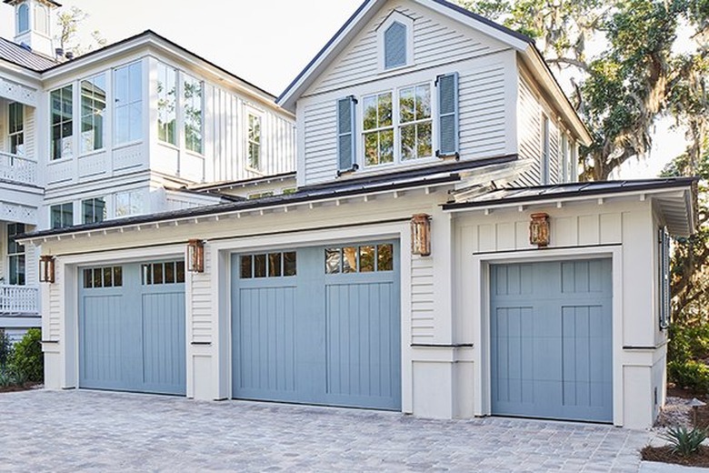 Light blue garage door colors on traditional white craftsman style home.